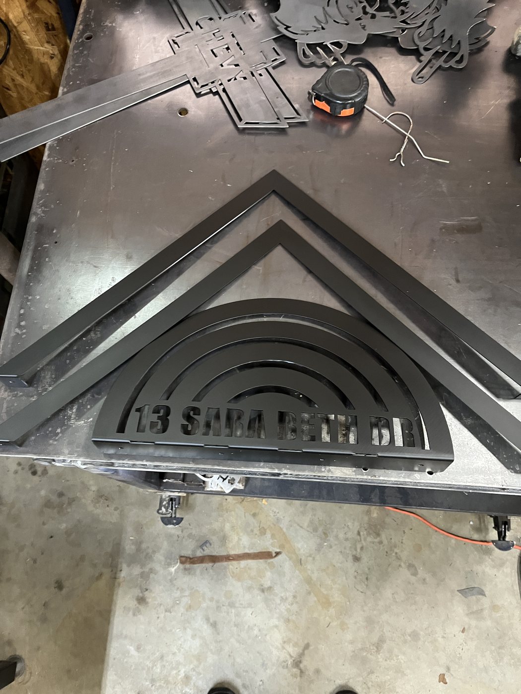 Large view of cut and painted custom mailbox topper in the shop