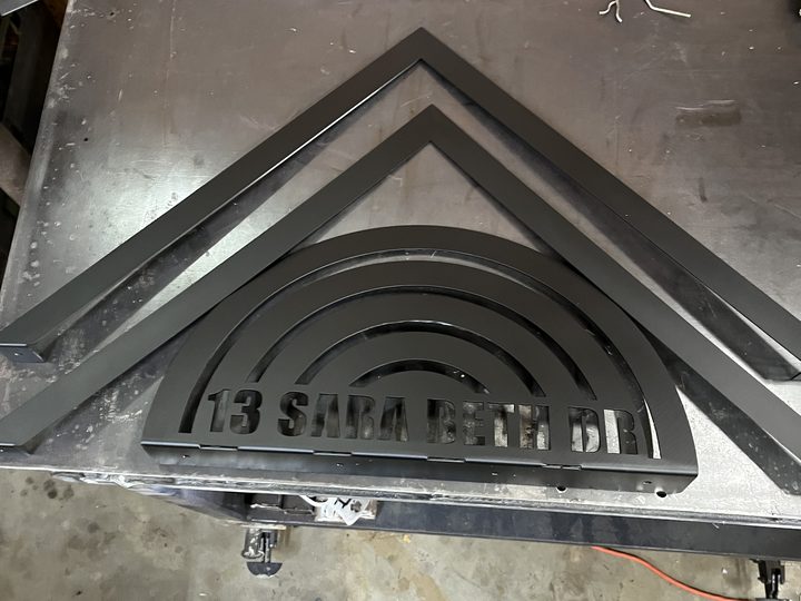 Small view of cut and painted custom mailbox topper in the shop