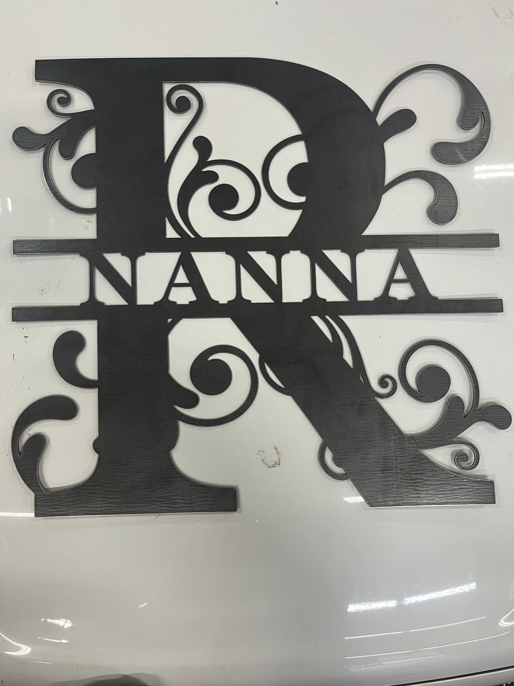 Large view of raw steel Nanna monogram detail