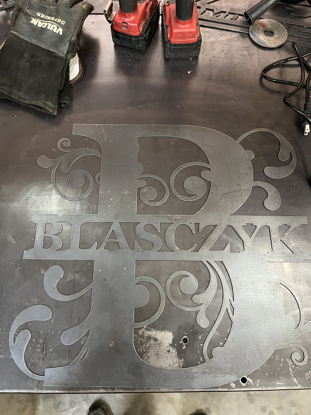 Large view of raw steel monogram on shop table