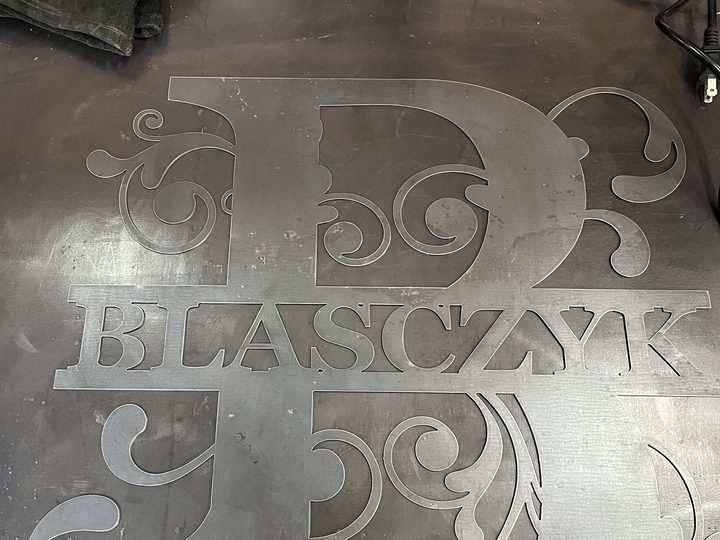 Small view of raw steel monogram on shop table